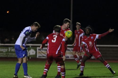 Enfields Liam Hope (L) heads on goal, but straight to the keeper