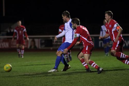 Enfields Liam Hope (white) challenged by Jack Parter