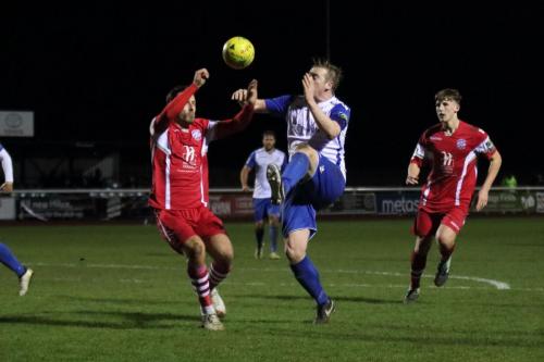 Enfields Mark Kirby (white) lifts the ball over Craig Stone