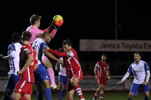 Tonbridge keeper Jonathan Henly catches cleanly under pressure from Simon Thomas