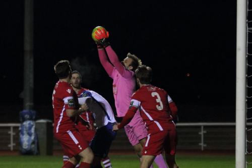 Tonbridge keeper Jonathan Henly collects a cross