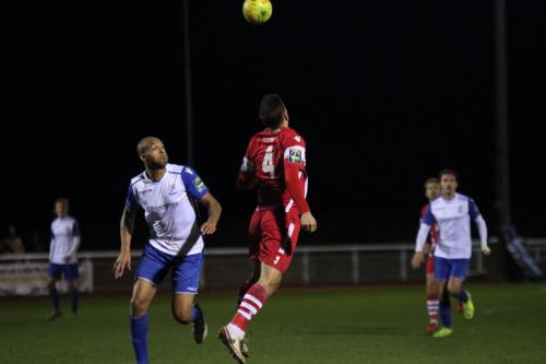 Tonbridges Craig Stone (R) heads clear from Simon Thomas