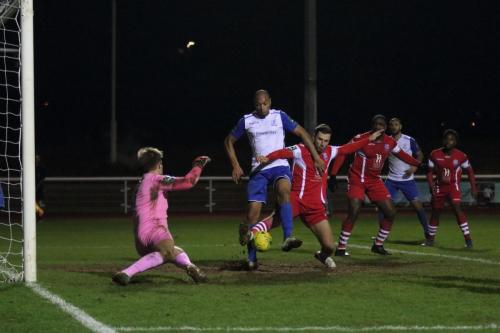 Tonbridges Craig Stone (red) makes sure Simon Thomas cant get a shot on goal