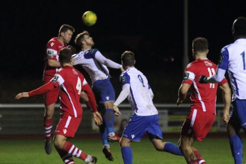 Tonbridges Sonny Miles (red) heads clear from Dan Rumens with just a hint of a pull on his shirt