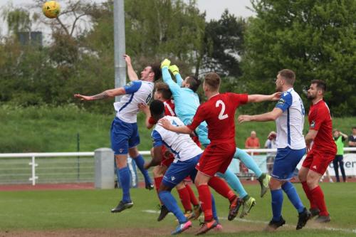 Enfields Matt Johnson (L) heads over the bar after Worthing keeper Lucas Covolan misjudges a corner