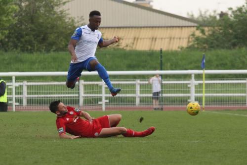 Enfields Ryan Blake hurdles a sliding tackle from Alex Parsons