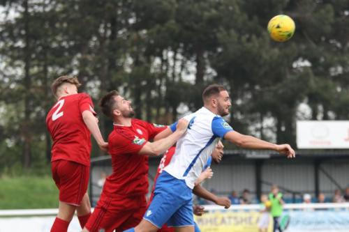 Worthings Aaran Racine (centre) heads clear from Mat Mitchel-King