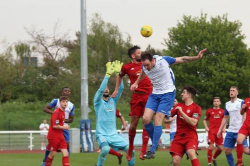 Worthings Alex Parsons (red heads clear from Matt Johnson