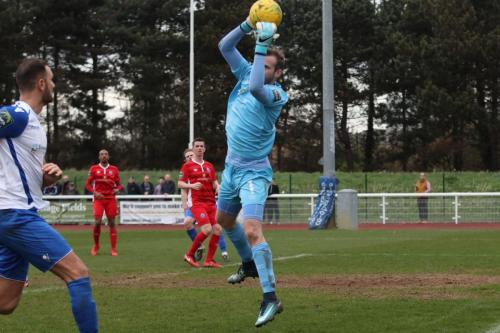 Billericay keeper Alan Julian catches as Mat Mitchel-King waits for any mistake