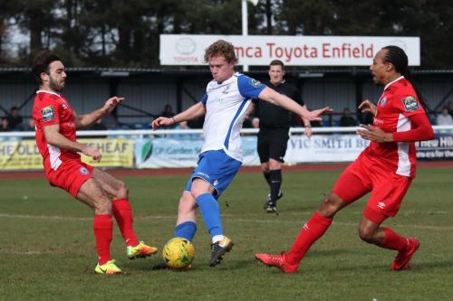 Billericays Sam Deering (L) and Ricky Modeste challenge Aaron Greene
