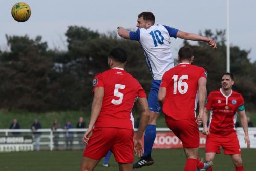Enfields Brad Wadkins (10) wins a header