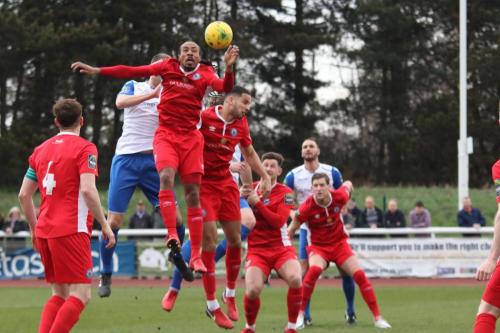Enfields Brad Wadkins (white, L) challemges Ricky Modeste
