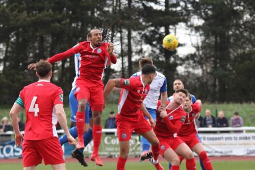 Enfields Dan Rumens (white, centre) heads over the bar
