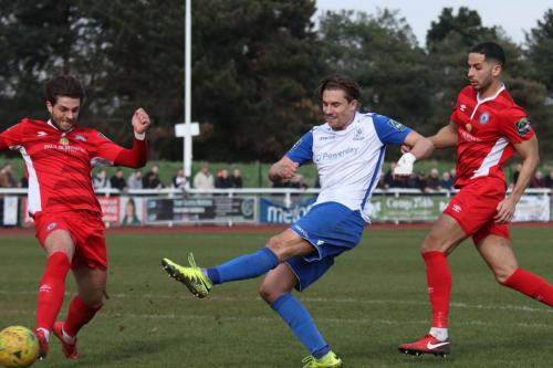 Enfields Sam Youngs shoots past an  attempted block from Sam Deering (L) as Joe Kizzi tries to get back to cover