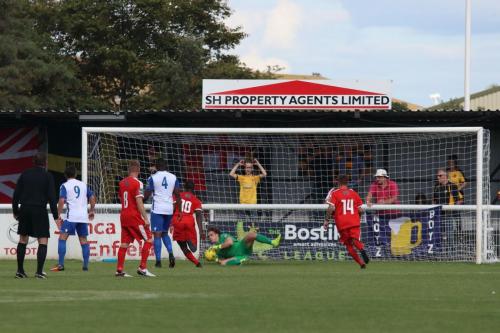 Enfield keeper Joe Wright saves from a Folkestone free kick