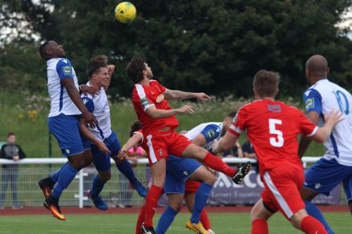 Enfields Rob Bartley (L) and Sam Youngs (2nd L) challenge at a free kick