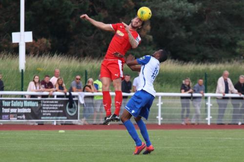 Folkestones Matthew Newman (red) and Enfields Ralston Gabriel