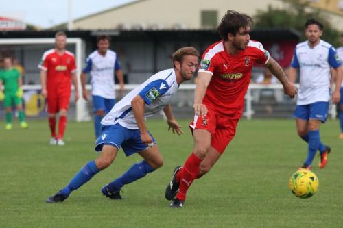 Folkestones Matthew Newman (red) and Enfields Robbie Rees
