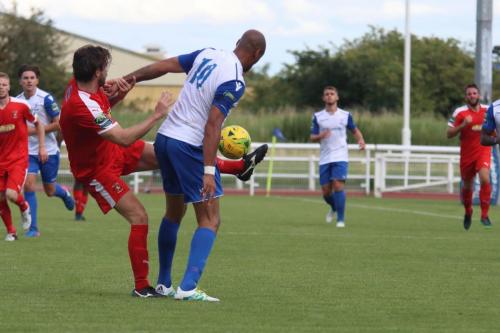 Folkestones Matthew Newman (red) challenges Simon Thomas