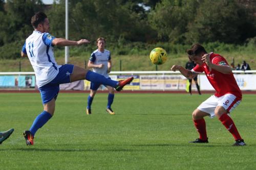 Enfields Drew Roberts (L) and Harlows James Shepherd stretch for the ball  Roberts was penalised for a high foot