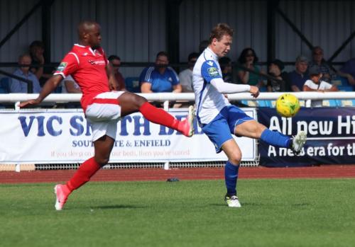 Enfields Mickey Parcell, making his 100th appearance for the club, crosses as Nigel Neita tries to block