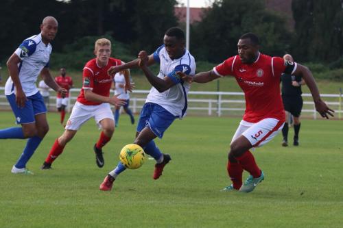 Enfields Ryan Blake (white, R) tries to go past Stanley Muguo