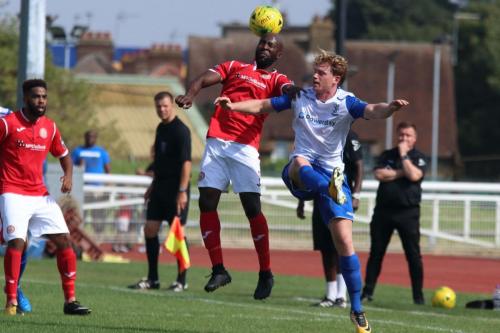 Harlows Junior Dadson (red) challenges Aaron Greene
