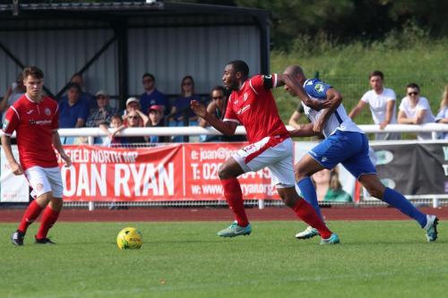 Harlows Stanley Muguo (centre) brings the ball out of defence chased by Simon Thomas