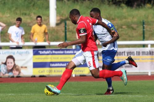 Harlows Stanley Muguo (red) and Enfields Ryan Blake