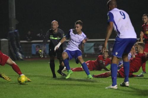 Ben Ward-Cochrane (white, L) is first to the loose ball and scores Enfields late equalising goal