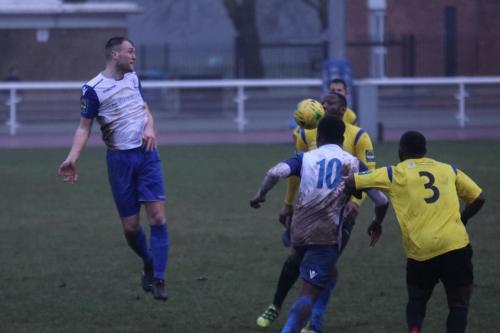 Enfields Brad Wadkins (L) and Ryan Blake and Kingstonians Andrew Musungu (3) and Rob Bartley