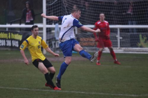 Enfields Mark Kirby clears from Greg Cundle