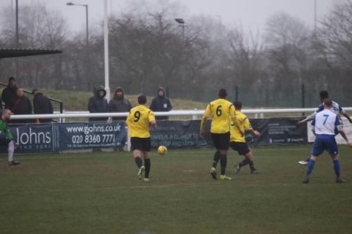 Enfields Ryan Blake (obscured by no 7, Ryan Blackman) hits the post from the edge of the box