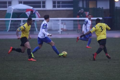 Enfields Sam Youngs (white, L) tries to pick out Tyler Campbell on the wing  The Kingstonian defenders are Connor Hunte (L) and Andrew Musungu