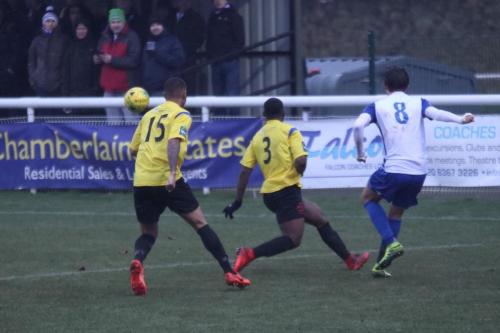 Enfields Sam Youngs crosses despite the attentions of Connor Hunte (15) and Andrew Musungu