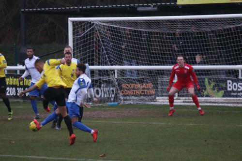 Kingstonians Connor Hunte (yellow) shoots as Tyler Campbell tries to block
