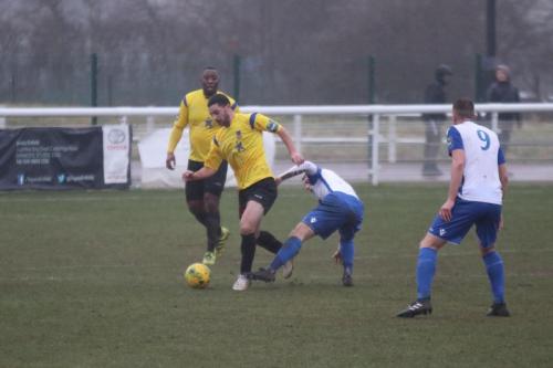 Kingstonians Michael West (yellow) challenged by Ryan Blackman