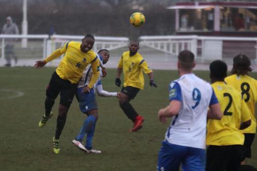 Kingstonians Rob Bartley (L) heads clear from Ryan Blake