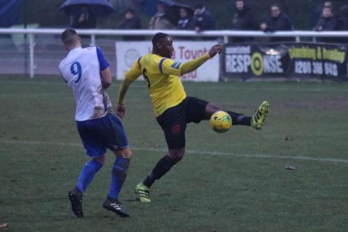 Kingstonians Rob Bartley (R) clears from Brad Wadkins