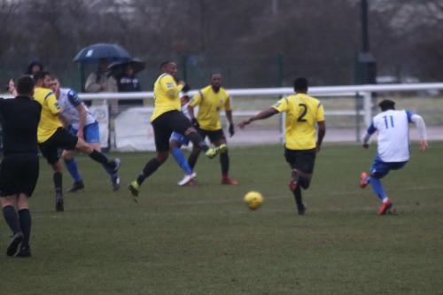 With the referee playing advantage, Enfields Tyler Campbell (11) fires home from outside the penalty area