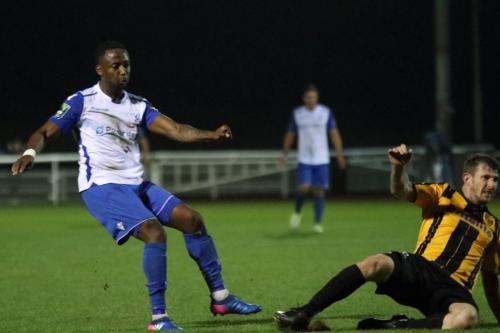Enfields Ryan Blake (L) shoots as Reece Prestedge tries to block