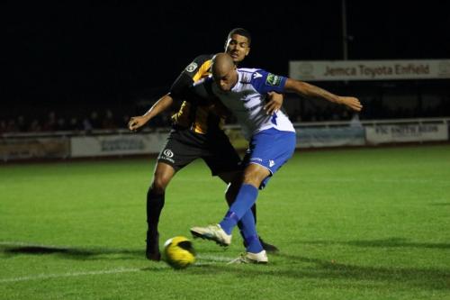 Enfields Simon Thomas shoots despite the attentions of Alex Wynter