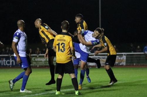 Enfields Taylor McKenzie (white, R) challenges for a long throw in