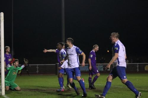 Enfield celebrate their late equaliser as Tooting keeper Matte Pierson appeals in vain for a foul