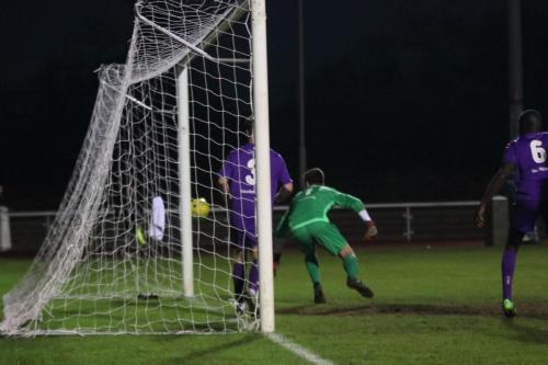Enfields Mark Kirby hits the post with a header