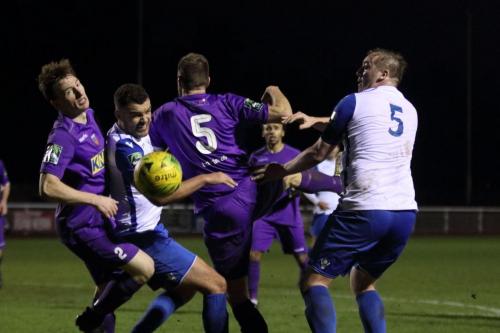 Tootings Eddie Dines (L) and Sam Flegg and Enfields Taylor McKenzie and Mark Kirby (R) challenge at a set piece
