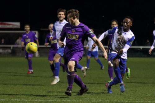 Tootings Eddie Dines (purple) clears from Ryan Blake