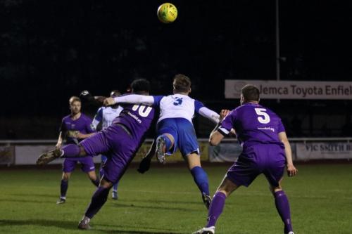 Tootings Omar Folkes (L) and Enfields Dan Rumens challenge at a free kick