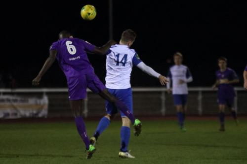 Tootings Quincy Rowe (L) heads clear from Liam Hope