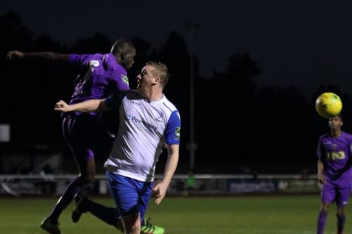 Tootings Quincy Rowe (L) heads clear from Mark Kirby